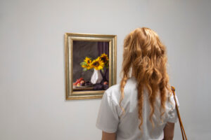 A woman admiring a painting on the wall.